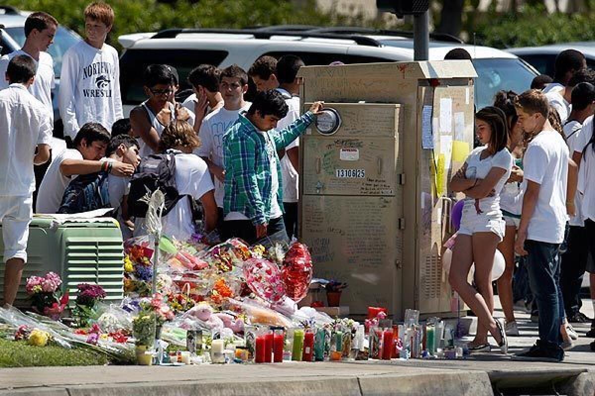 Northwood High School students at a roadside memorial for Ashton Sweet at the intersection of Culver Drive and Irvine Boulevard in Irvine.