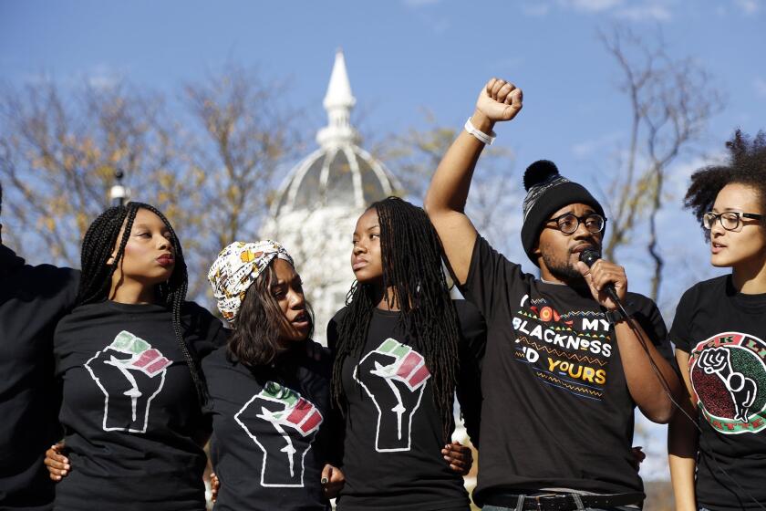 University of Missouri graduate student Jonathan Butler speaks to students Monday after university system President Tim Wolfe announced he would resign. Butler had gone on a hunger strike to force the leader's ouster.