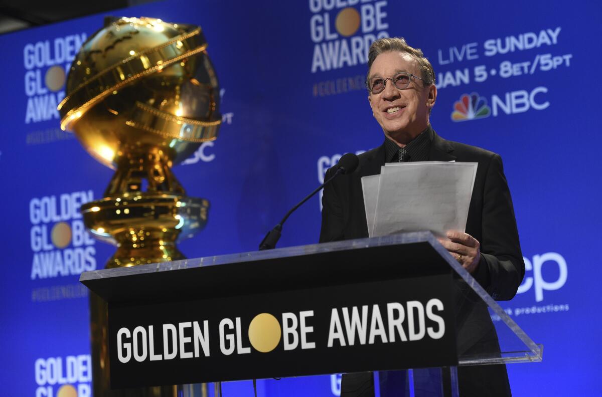 Tim Allen stands at a lectern labeled "Golden Globe Awards."