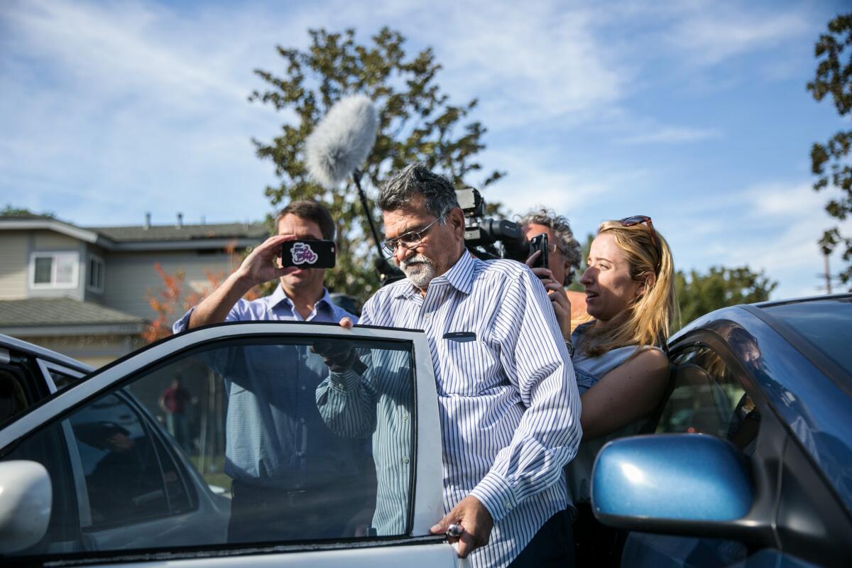 CORONA, CALIF. -- MONDAY, DECEMBER 7, 2015: Syed Farook, father of the suspect in the deadly San Bernardino mass shootings, is swamed by TV reporters as he arrives at his home in Corona, Calif., on Dec. 7, 2015. Farouk senior did not respond to any of their questions. (Marcus Yam / Los Angeles Times)