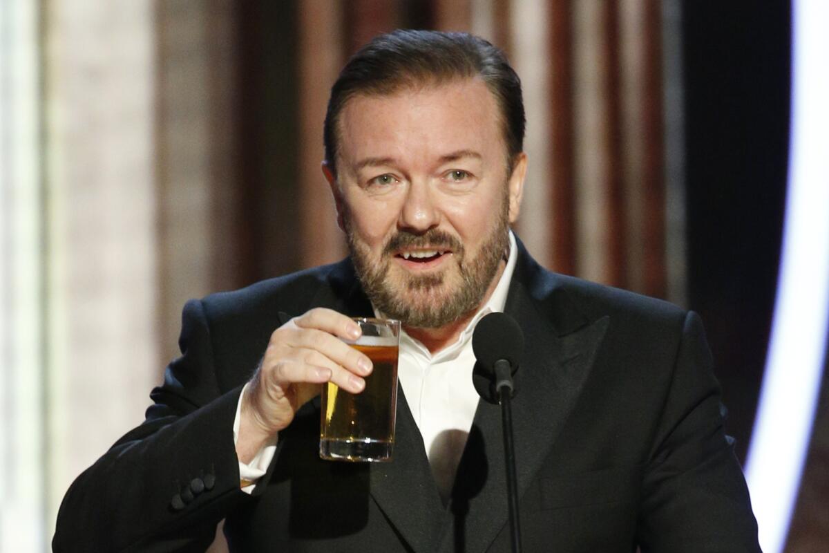 Ricky Gervais takes a drink while hosting the Golden Globe Awards in 2020.