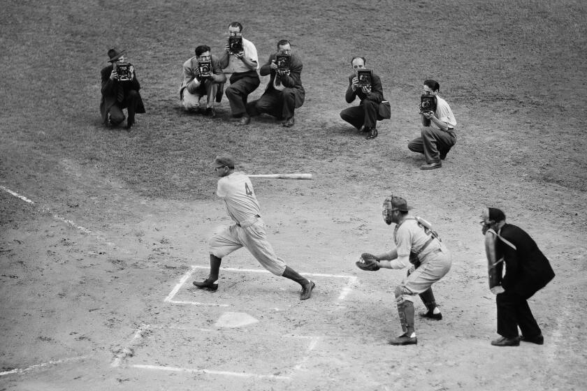 Two dozen former Dodgers stars met in a three inning exhibition at Ebbets Field, Sept. 22, 1940. It was played between games of the Brooklyn-Philadelphia double header. Zach Wheat is at bat, Hank Deberry is catcher and Tom Dunn is umpire. (AP Photo)