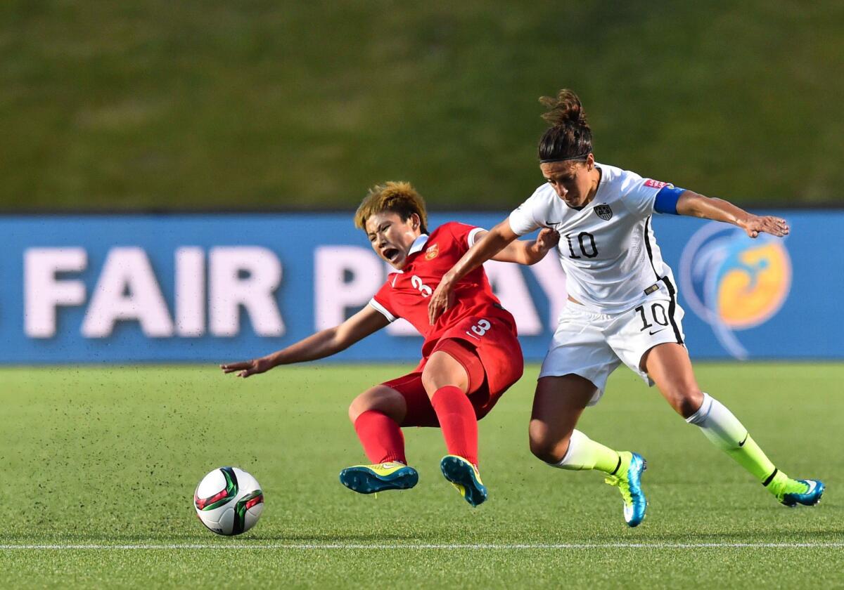 U.S. captain Carli Lloyd (10) tries to get around China's Li Jiayue to gain possession of the ball in the second half of a Women's World Cup quarterfinal.
