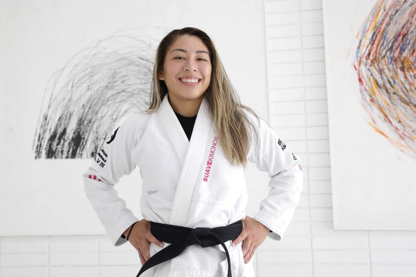 Jessa Khan, an MMA fighter in jiu jitsu, stands in the Art of Jiu-Jitsu academy in Costa Mesa on Thursday. Khan is preparing to compete on the upcoming ONE Championship Fight Night.