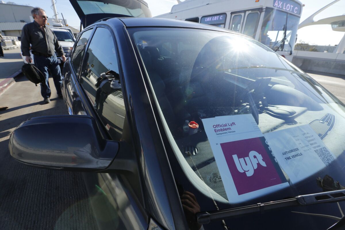 Lyft and GM are starting a short-term car rental program for Lyft drivers. Above, a Lyft car at Los Angeles International Airport.