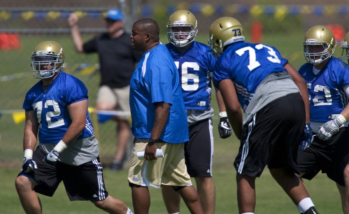 UCLA offensive line coach Adrian Klemm, center, and his fellow assistant coaches received significant pay increases for the 2014 season.