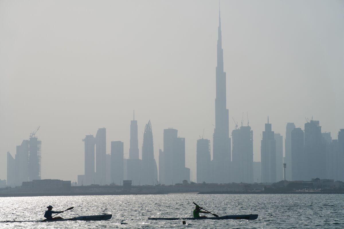 Kayakers race in front of the Burj Khalifa, the world's tallest building, off the coast of Dubai, United Arab Emirates