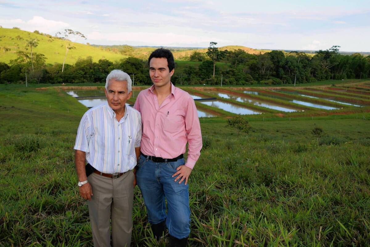 Amazon's International Trade President Alvaro Marles and Vice President Carlos Ramirez are shown near the company fish farm in Florencia, Colombia. The company expects to ship 20,000 arowana fish to Asia this year.