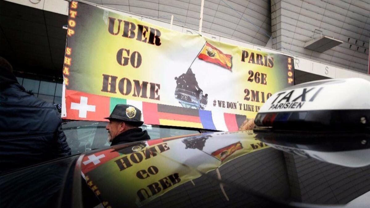 Taxi drivers demonstrate in Paris against what they consider unfair competition from rival services such as Uber in early 2016.