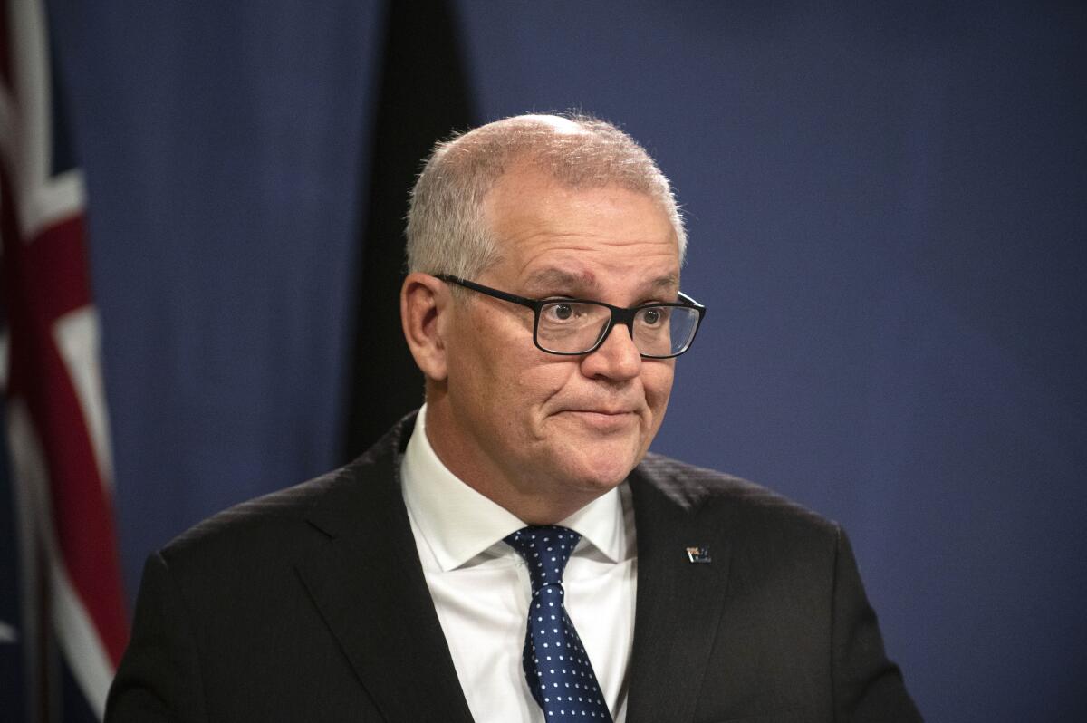 Former Australian Prime Minister Scott Morrison speaks during a news conference in Sydney, Wednesday, Aug. 17, 2022. Morrison defends his decision to secretly appoint himself to five ministerial roles when he was Australia's prime minister, saying it was a necessary step during the depths of the coronavirus crisis. (AAP Image/Flavio Brancaleone)