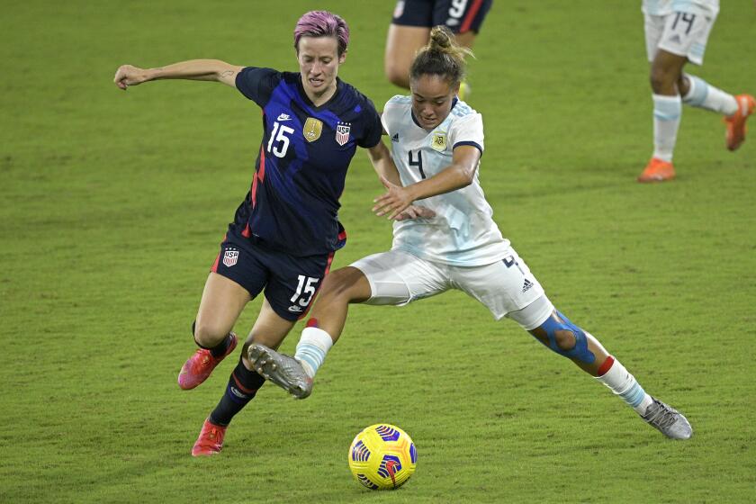 United States forward Megan Rapinoe (15) and Argentina defender Marina Delgado (4) compete for a ball during the second half of a SheBelieves Cup women's soccer match, Wednesday, Feb. 24, 2021, in Orlando, Fla. (AP Photo/Phelan M. Ebenhack)