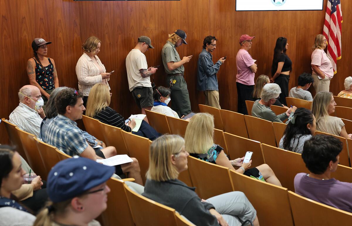 People line-up to make public comments during a Costa Mesa City Council meeting.