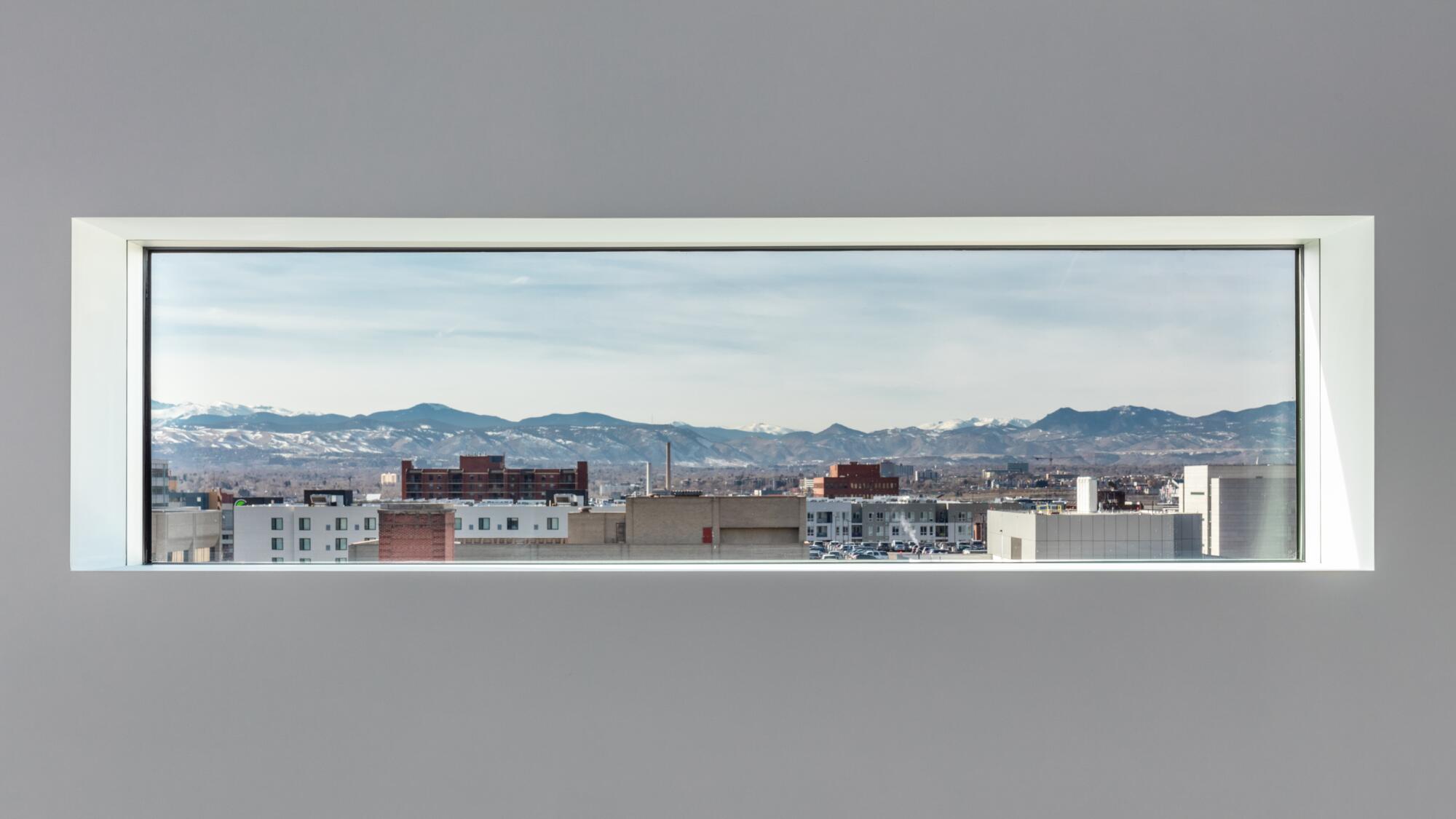 A view of the Rocky Mountains is framed by a slender horizontal window.