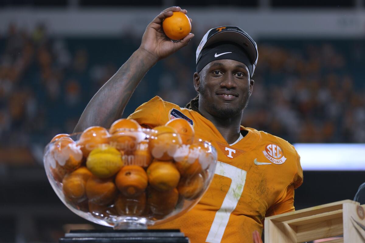 Tennessee quarterback Joe Milton III throws oranges after the Volunteers' win over Clemson in the Orange Bowl on Dec. 30.