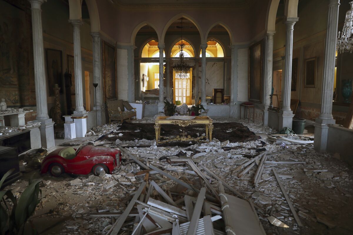 Debris from the ceiling and walls cover the floor of a room in the 150-year-old Sursock Palace that was damaged by the Aug. 4 explosion that hit the seaport of Beirut, Lebanon, Monday, Sept. 14, 2020. Restoring Beirut's architectural heritage from the August blast will take hundreds of millions of dollars and costs will quickly rise if no action is taken ahead of the onset of the rainy season in less than two months time, international experts announced Tuesday. (AP Photo/Bilal Hussein)