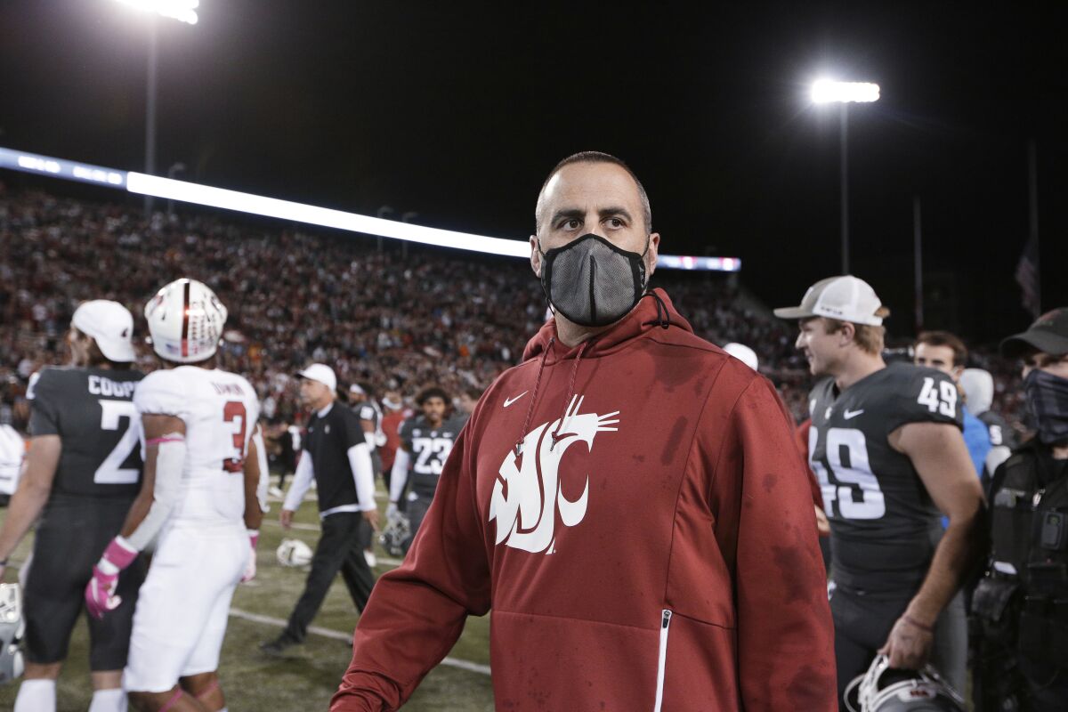 Washington State coach Nick Rolovich walks on the field after the team's NCAA college football game against Stanford, Saturday, Oct. 16, 2021, in Pullman, Wash. Washington State won 34-31. (AP Photo/Young Kwak)