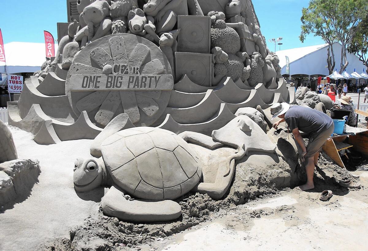 Sculptor Jon Woolworth helps finish the cake.