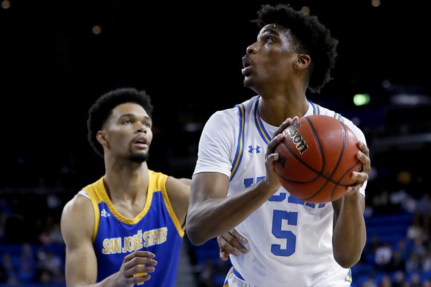 LOS ANGELES, CALIF. - DEC. 1, 2019. Bruins guard Chris Smith goes to the basket against San Jose State's Zach Chappell in the first half at Pauley Pavilion in Los Angeles on Sunday, Dec. 1, 2019. (Luis Sinco/Los Angeles Times)