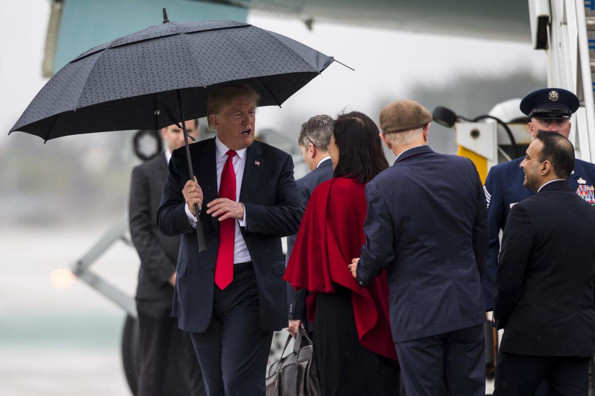 President Donald Trump arrives in the rain at Los Angeles International Airport on March 13.