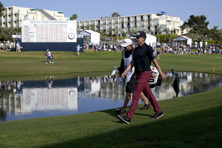 Mackenzie Hughes walks up the 18th fairway during the third round of the U.S. Open.