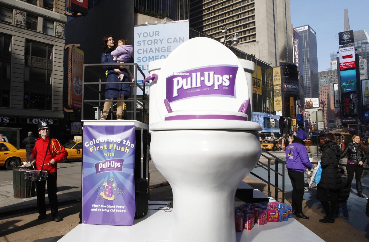 A giant outdoor toilet display advertises for Pull-Ups 