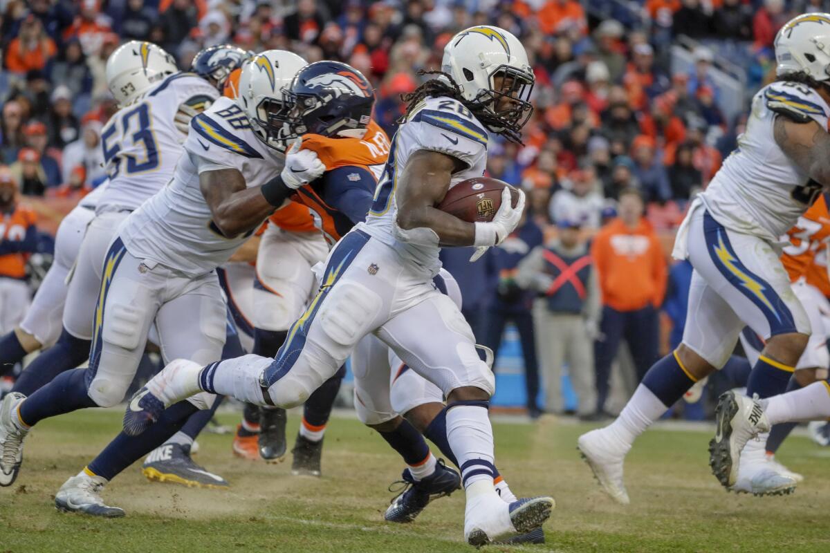 The Chargers' Melvin Gordon looks for running room against the Denver Broncos.