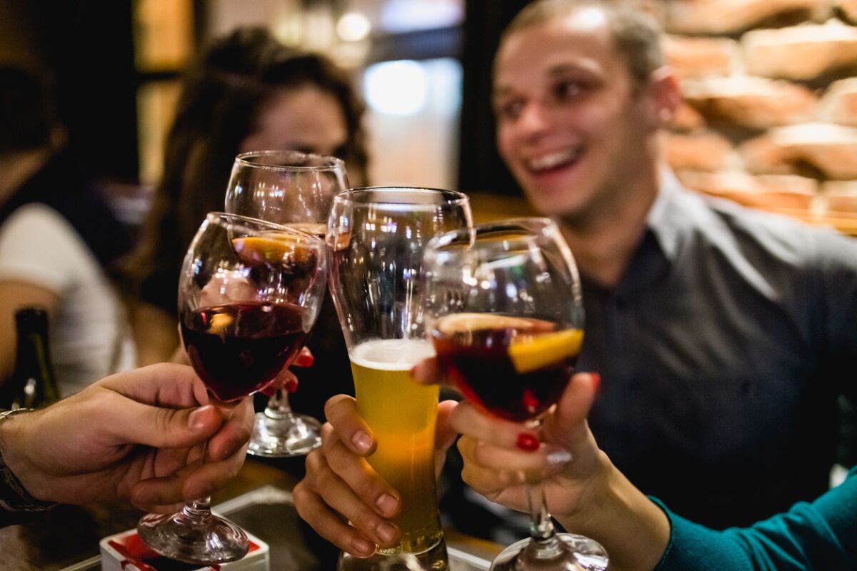 Group Of Friends Enjoying Evening Drinks In Bar. (iStock)