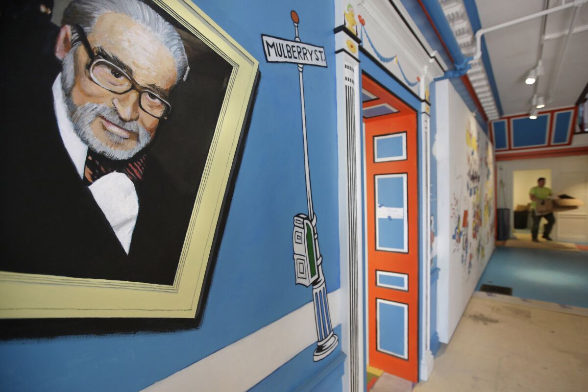 A mural featuring Theodor Geisel, known as Dr. Seuss, is pictured near an entrance at The Amazing World of Dr. Seuss Museum. 