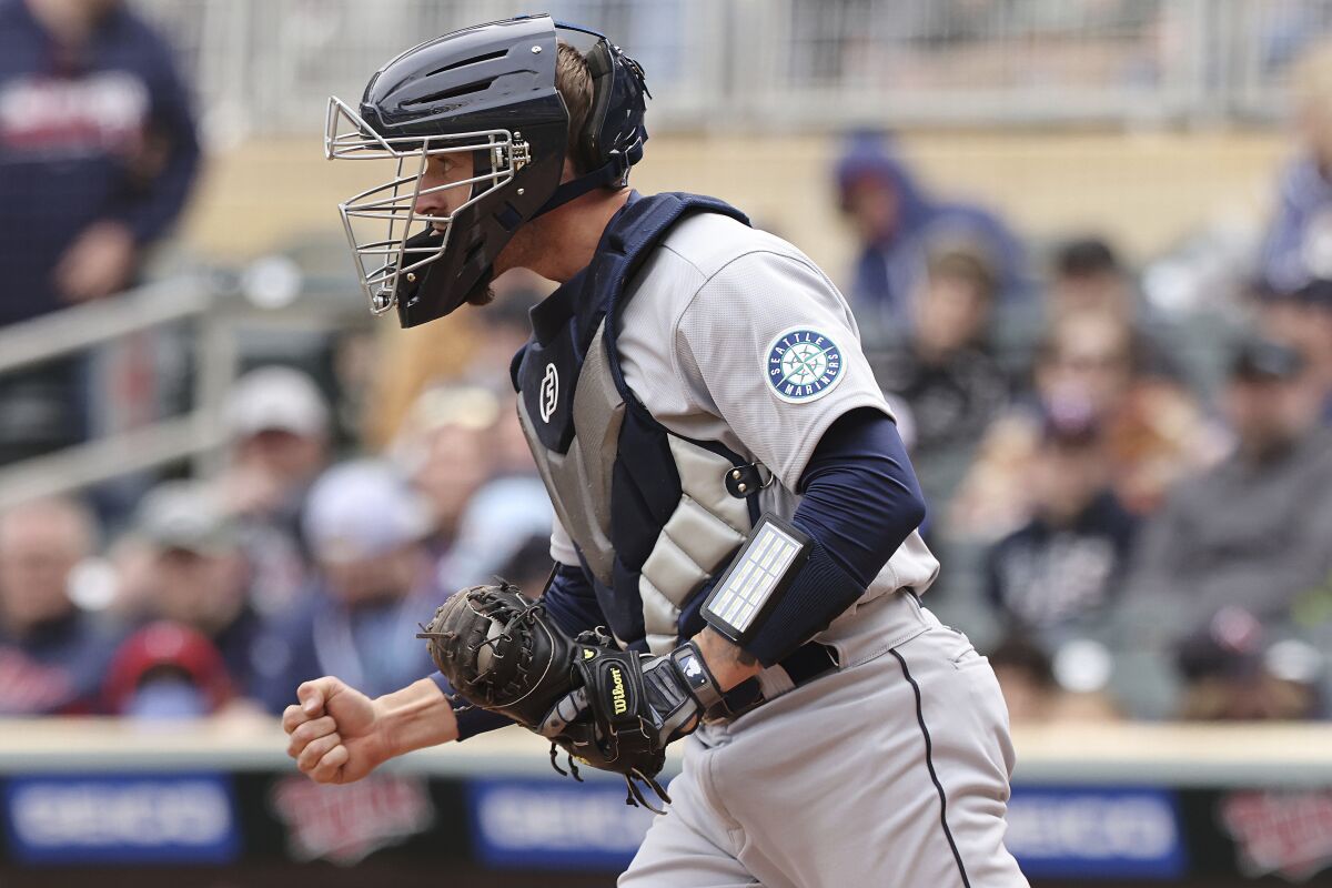Seattle Mariners catcher Tom Murphy (2) reacts after winning 4-3 against the Minnesota Twins at the end of the ninth inning of a baseball game Saturday, April 9, 2022, in Minneapolis. (AP Photo/Stacy Bengs)