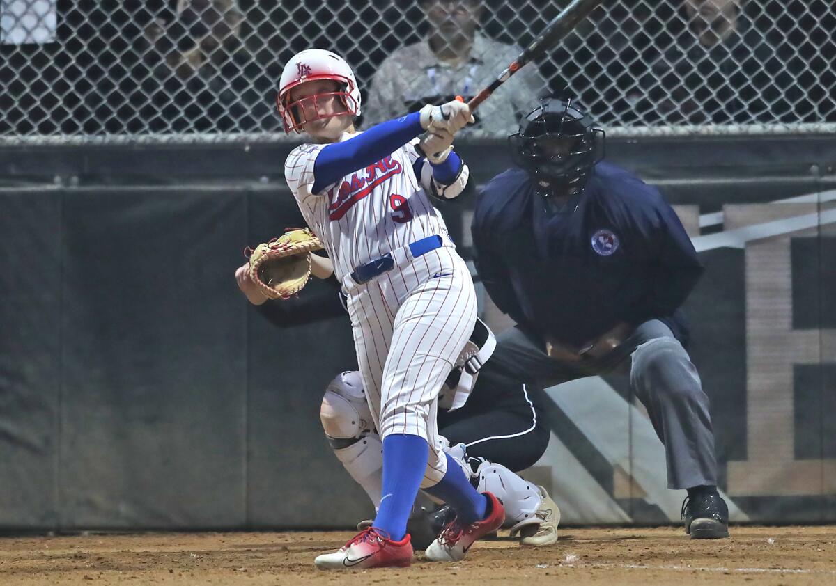 Los Alamitos right fielder Callie Fitzpatrick belts a home run against Huntington Beach in the sixth inning on Tuesday.