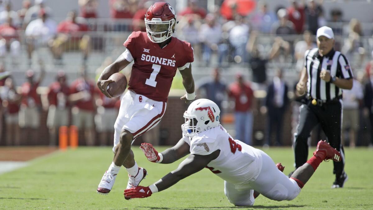 Oklahoma quarterback Kyler Murray steps away from Florida Atlantic defensive tackle William Davis on Sept. 1.