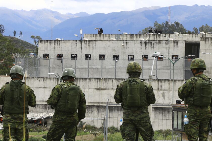 Soldiers stand guard outside Turi prison after a deadly prison riot in Cuenca, Ecuador, Sunday, April 3, 2022.(AP Photo/Marcelo Suquilanda)