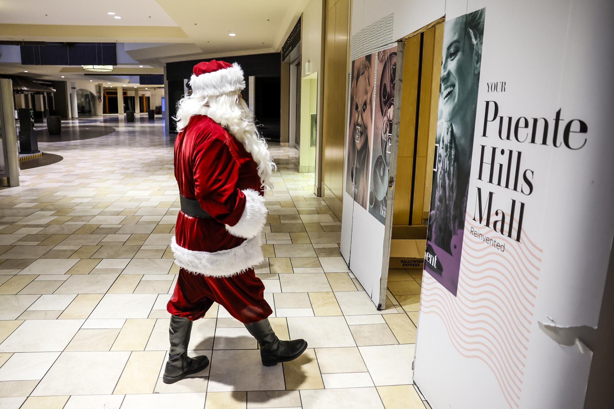Santa Claus, a.k.a. Albert Sanchez, heads to the break room during his shift at the Puente Hills Mall.
