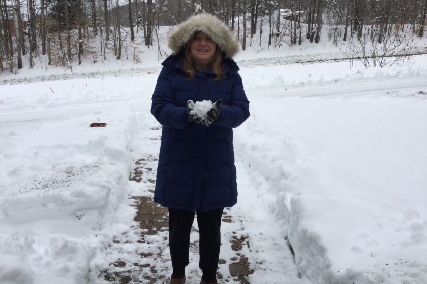 Jodi Cilley holds a snowball in Topsham, Vermont.
