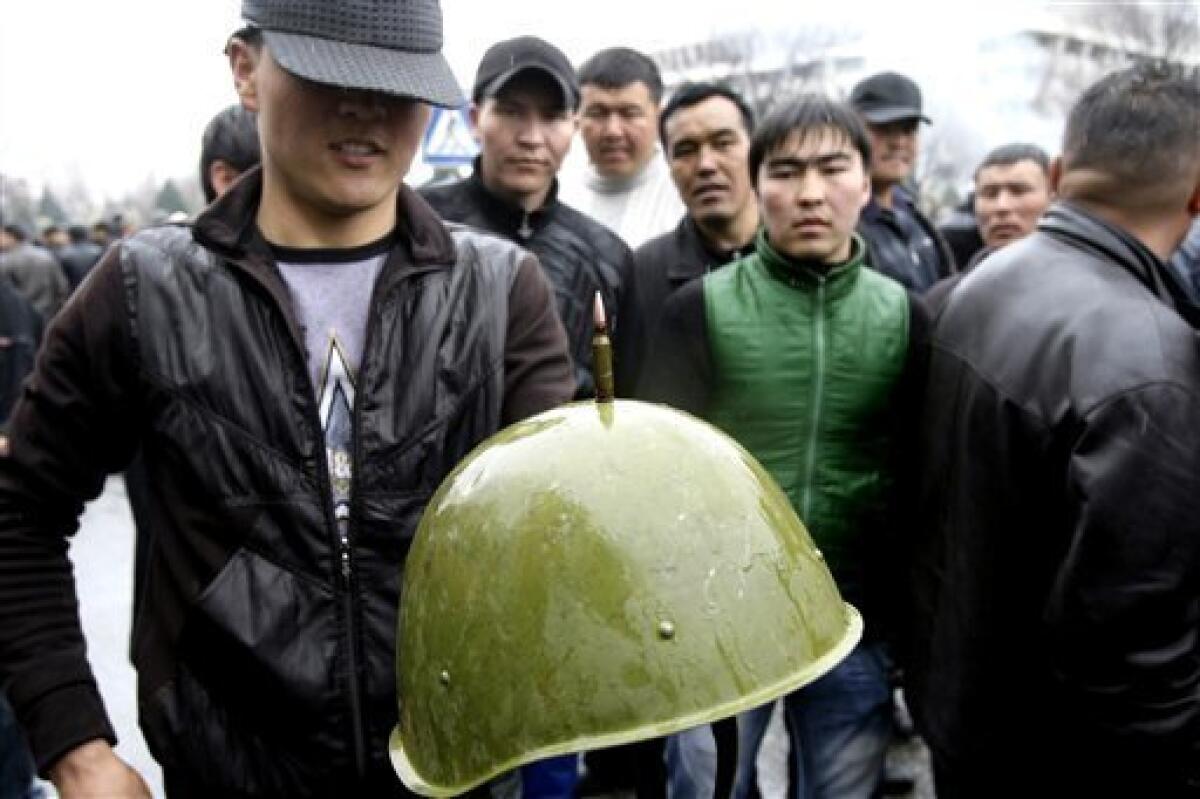 A Kyrgyz protester balances a bullet on top of a police helmet, during clashes with police in Bishkek, Kyrgyzstan, Wednesday, April 7, 2010. Police in Kyrgyzstan opened fire on thousands of angry protesters who tried to seize the main government building amid rioting in the capital as protests spread across the Central Asian nation. (AP Photo/Ivan Sekretarev)
