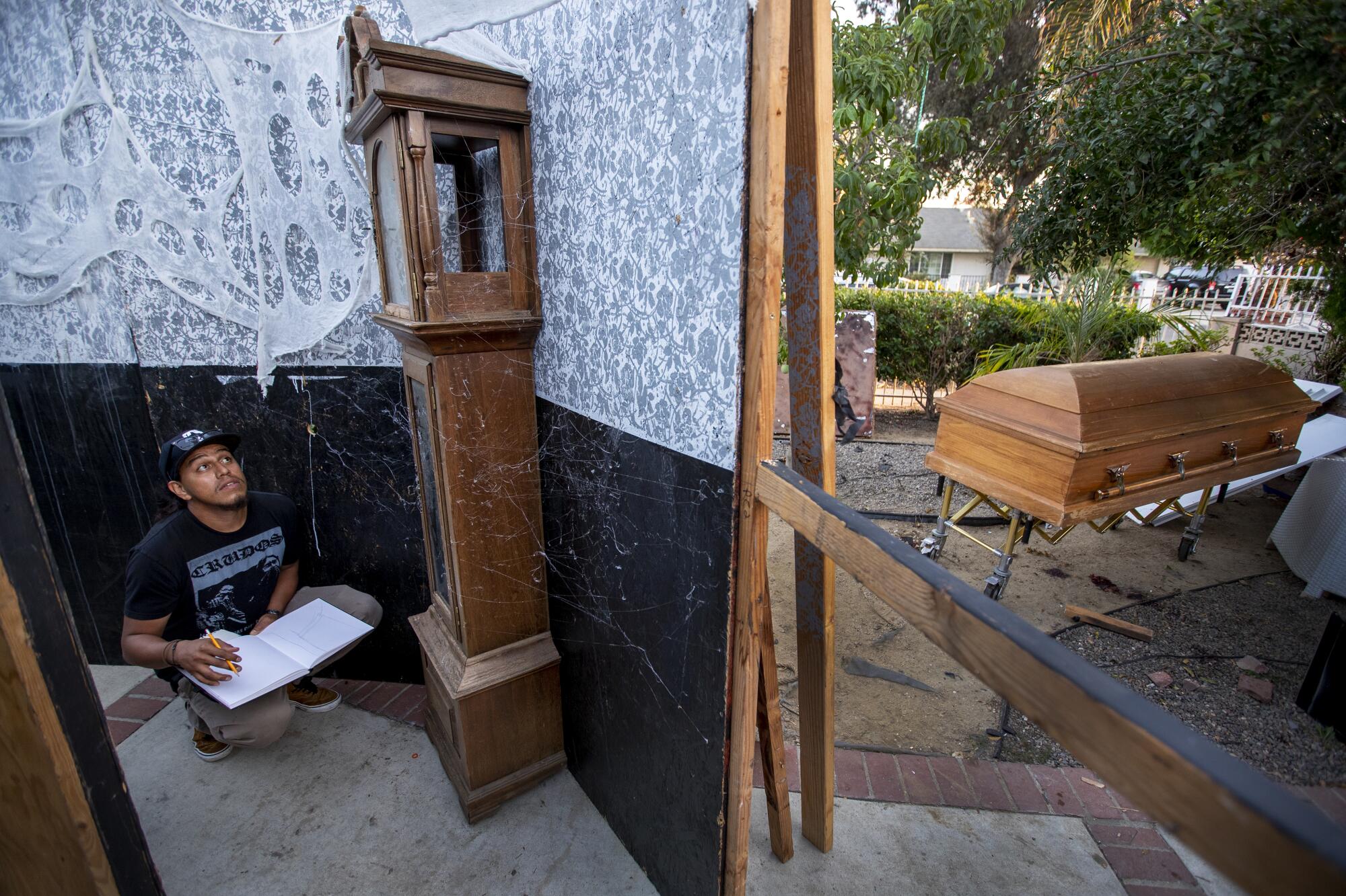 Eduardo Camarena, artist and set designer, draws up set plans for Santa Ana Haunt.