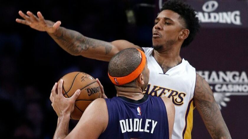 Lakers guard Nick Young (0) defends against Phoenix Suns forward Jared Dudley (3) going to the basket during the first half on Nov. 6.