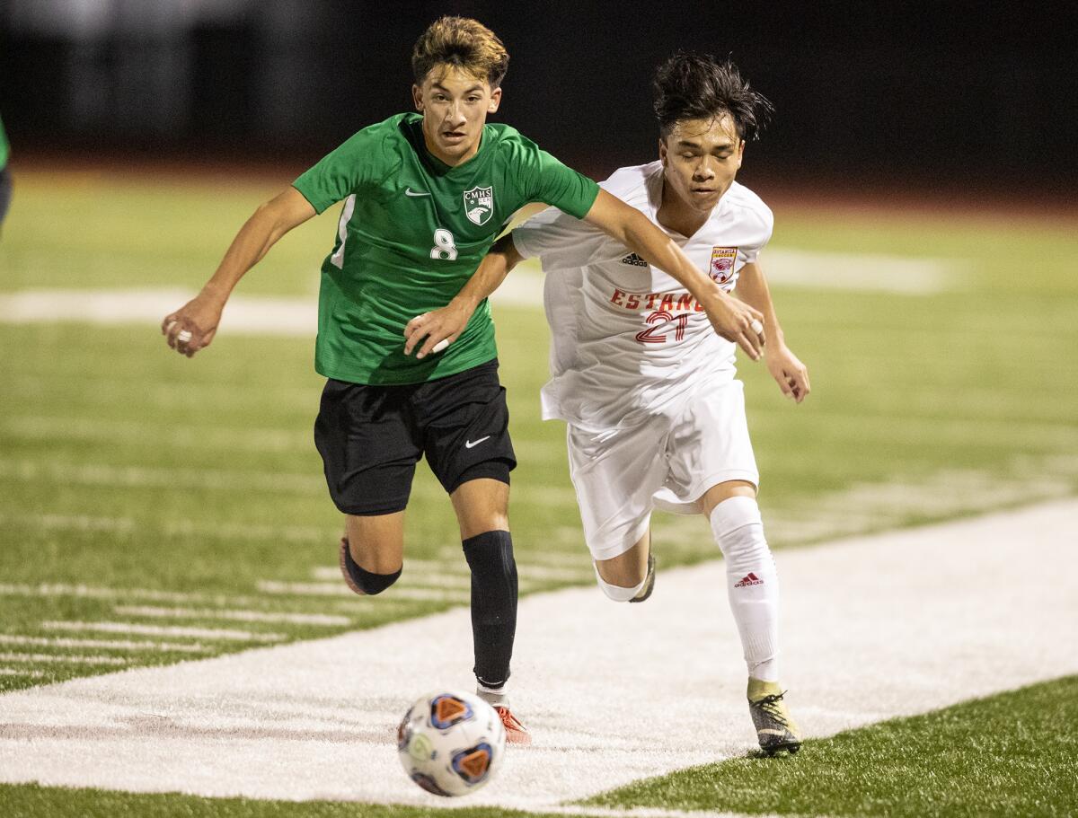 Costa Mesa's Isaiah Ponce and Estancia's Adrian Suarez battle for a ball on Wednesday.