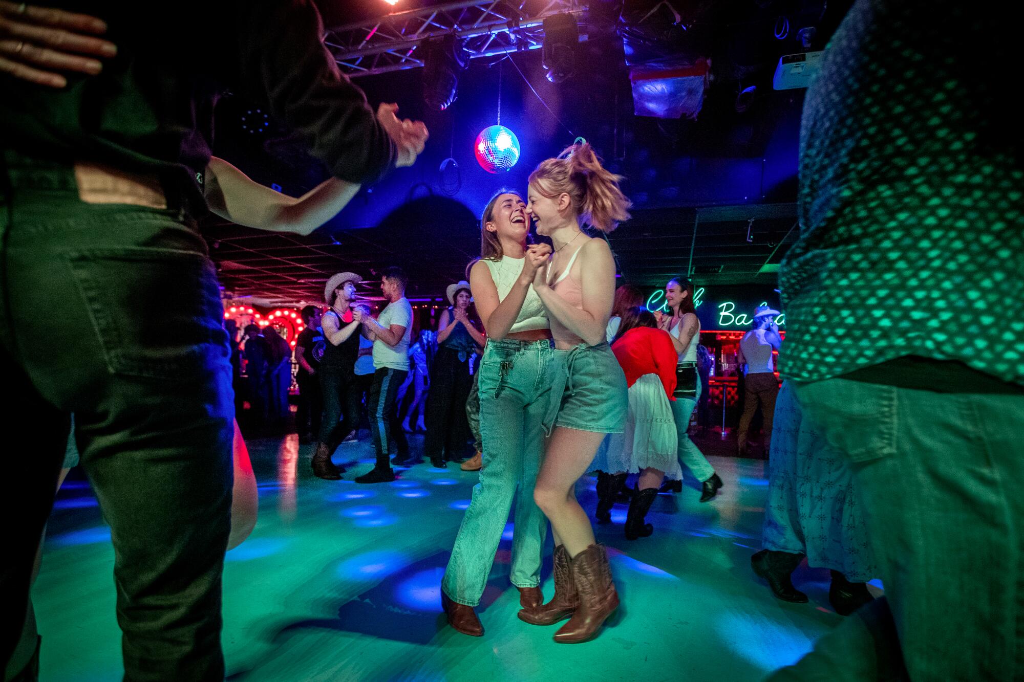 Couples dance at a queer line dancing night at Club Bahia.