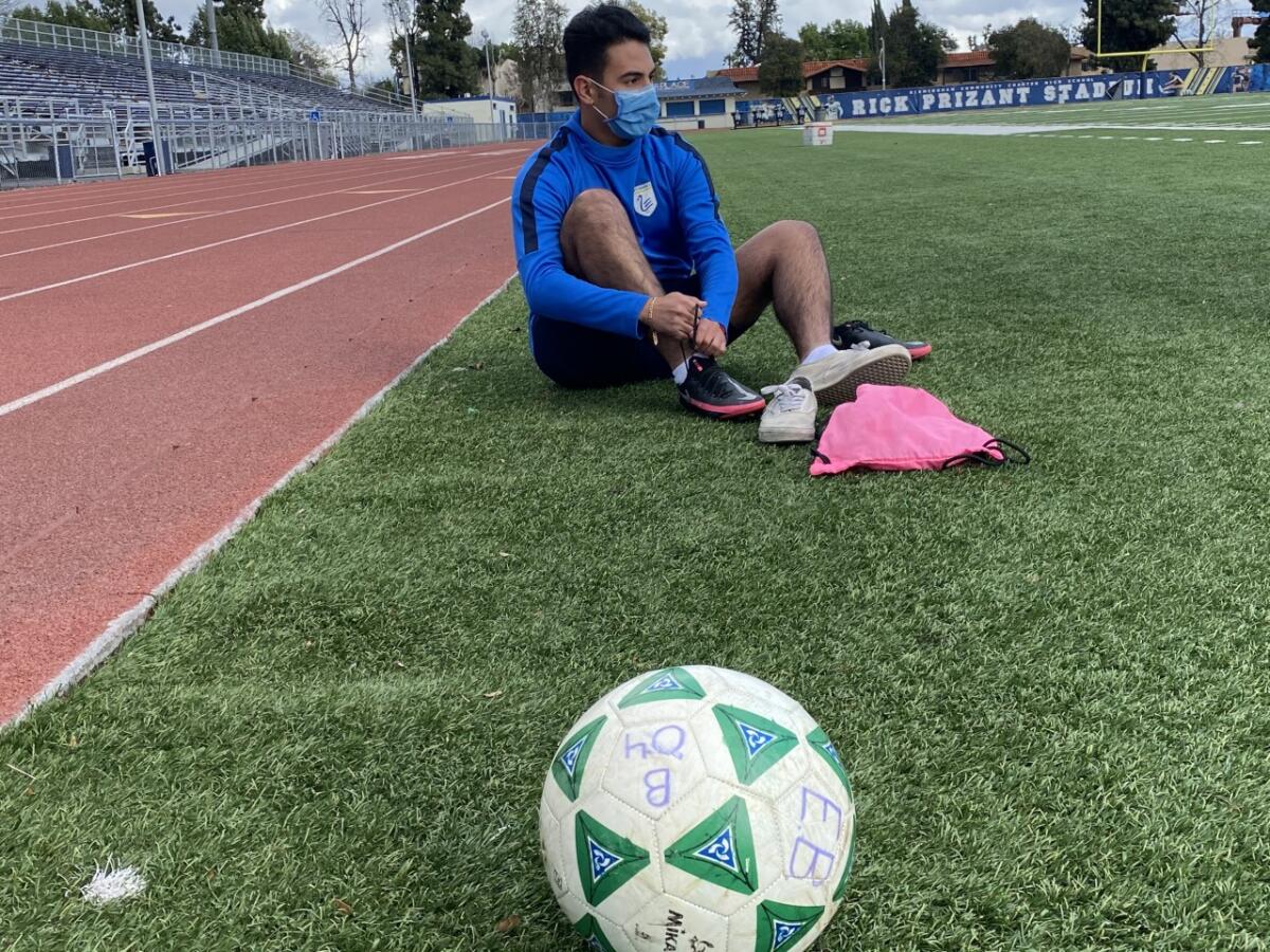 Birmingham soccer player Anthony Mercado laces up his shoes before his first practice with the team this spring.
