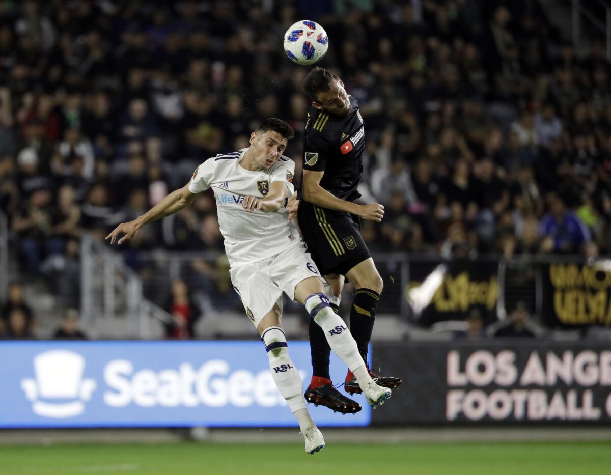 Los Angeles FC's Danilo Silva, right, heads the ball next to Real Salt Lake's Damir Kreilach (6) during the first half of an MLS soccer playoff match Thursday, Nov. 1, 2018, in Los Angeles.