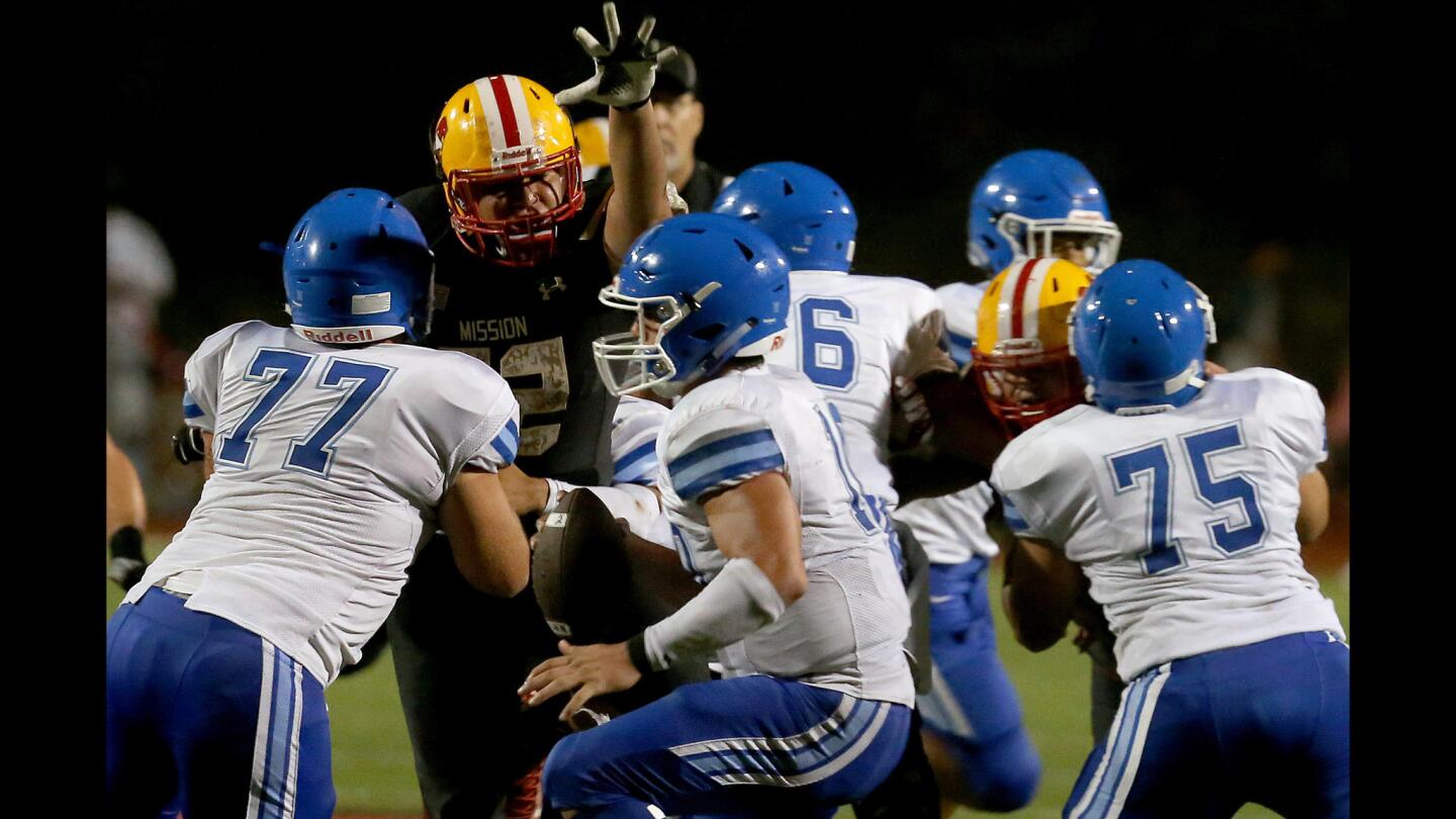 Norco quarterback Victor Viramontes feels the pressure from the Mission Viejo defense in the third quarter Friday night during a non-league game at Mission Viejo High.
