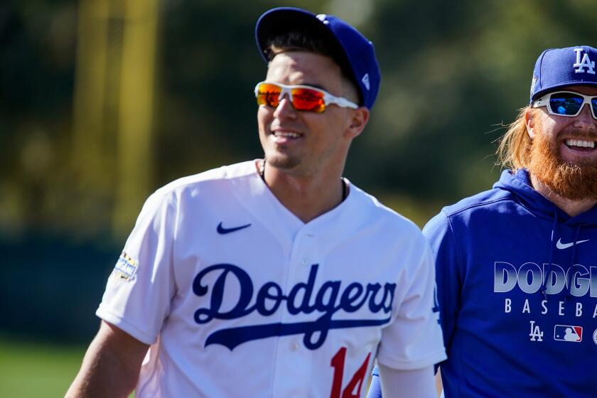 PHOENIX, ARIZ. - FEBRUARY 20: Los Angeles Dodgers Kiké Hernández (14) and Justin Turner (10) walk off field during practice at Spring Training at Cameback Ranch on Thursday, Feb. 20, 2020 in Phoenix, Ariz. (Kent Nishimura / Los Angeles Times)