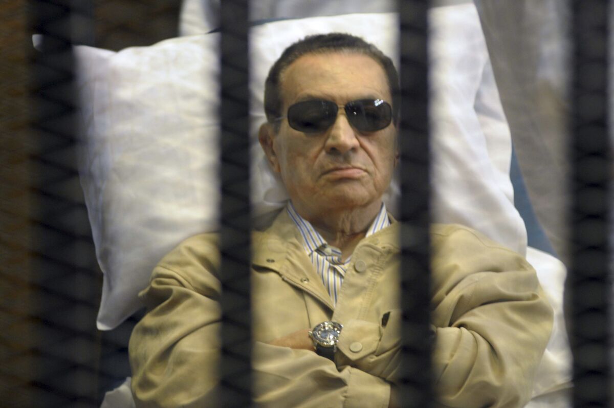 Former Egyptian President Hosni Mubarak attends his trial in a Cairo court on a stretcher.