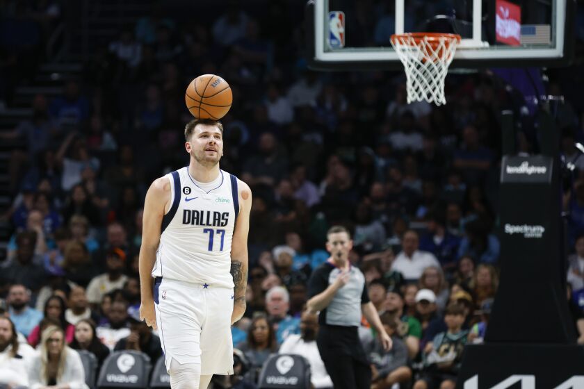 Dallas Mavericks guard Luka Doncic balances the basketball on his head after a foul was called on Dallas during the second half of an NBA basketball game against the Charlotte Hornets in Charlotte, N.C., Sunday, March 26, 2023. Charlotte won 110-104. (AP Photo/Nell Redmond)
