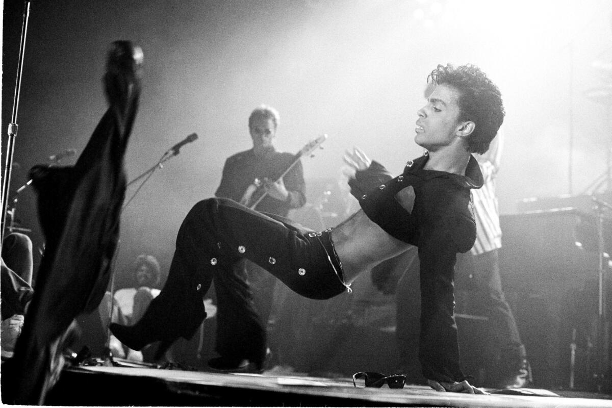 Prince performs on stage on the Hit N Run-Parade Tour at Wembley Arena in London in August 1986.