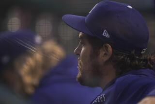 Dodgers pitcher Trevor Bauer looks on from the dugout during a game against the Washington Nationals on July 1, 2021.