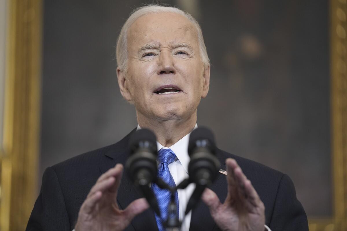 President Biden speaks at a microphone