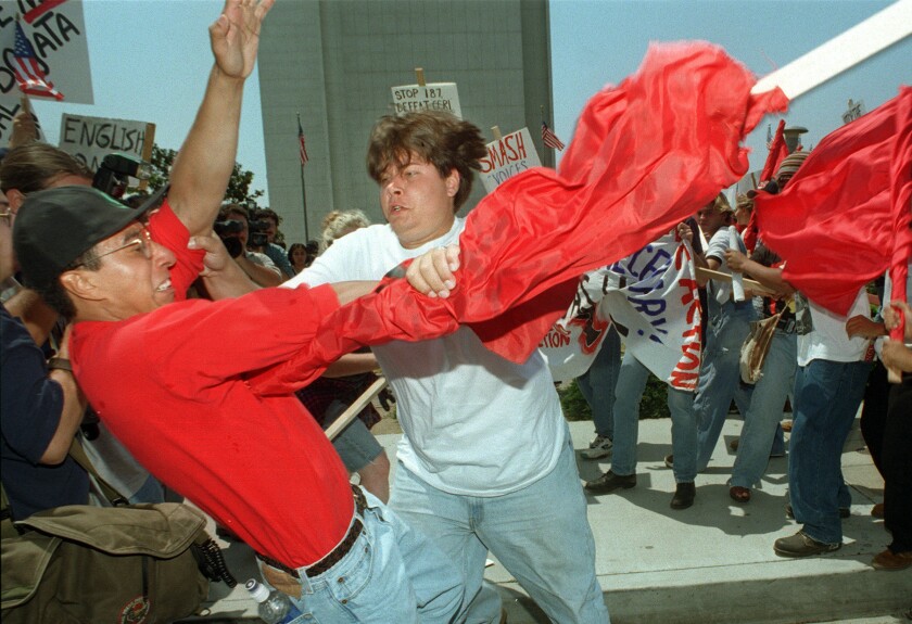 Pro and anti Proposition 187 protesters scuffle on the streets of Los Angeles in 1996. (Lori Shepler / Los Angeles Times)