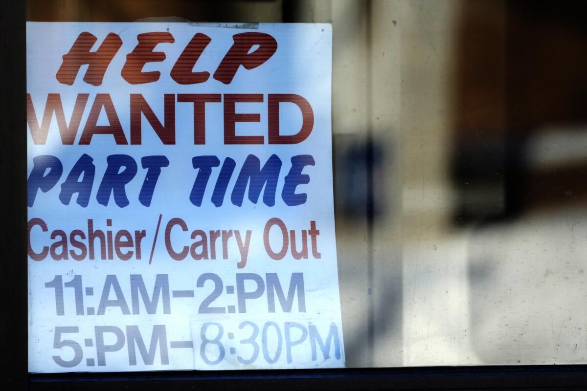 A help wanted sign is displayed at a restaurant 